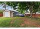 View of detached garage, assorted vehicles, yard and privacy fence at 618 Summerville Dr, Lawrenceville, GA 30046
