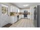 Bright kitchen with stainless steel appliances, white cabinetry, and a cozy breakfast nook area with a door to outside at 618 Summerville Dr, Lawrenceville, GA 30046