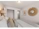 Well-lit bedroom featuring a closet and attractive wall mirror that complements the neutral bedding at 1021 Merritt Dr # 101, Villa Rica, GA 30180