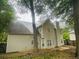 Exterior view of home with backyard and patio area partially obscured by trees at 108 Northcutt Station Pl, Acworth, GA 30101