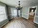 Well-lit dining space with hardwood floors and stylish chandelier, flowing into other living areas at 108 Northcutt Station Pl, Acworth, GA 30101