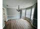 Bright dining room featuring hardwood floors, elegant lighting, and large windows at 108 Northcutt Station Pl, Acworth, GA 30101