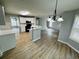 Bright kitchen with white cabinets, stainless sink and an open floorplan to the home's living spaces at 108 Northcutt Station Pl, Acworth, GA 30101