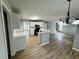 Open kitchen features white cabinets, an island with a sink, and modern black appliances at 108 Northcutt Station Pl, Acworth, GA 30101