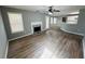 Open-concept living room with a fireplace, hardwood floors, and abundant natural light at 108 Northcutt Station Pl, Acworth, GA 30101