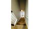 Carpeted staircase leading to the upper level of the home, with light gray walls and white railing at 108 Northcutt Station Pl, Acworth, GA 30101