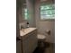 A modern bathroom with a sleek vanity and fixtures, complemented by white subway tile walls at 2493 Springdale Rd, Atlanta, GA 30315