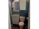 Compact bathroom featuring a white vanity, modern fixtures, and blue accent wall, offering a stylish design at 2493 Springdale Rd, Atlanta, GA 30315