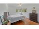 Bedroom with dark wood floors, white walls, and sunny windows at 2493 Springdale Rd, Atlanta, GA 30315