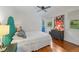 Bright bedroom with natural light, a teal upholstered headboard, and hardwood floors at 2493 Springdale Rd, Atlanta, GA 30315