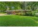 Well-maintained brick home with a lush green lawn and mature trees at 2493 Springdale Rd, Atlanta, GA 30315