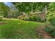 Beautifully landscaped front yard with a view of the charming brick house at 2493 Springdale Rd, Atlanta, GA 30315