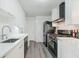 Modern kitchen with white cabinets, sleek countertops, and stainless steel appliances at 2493 Springdale Rd, Atlanta, GA 30315