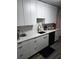Modern kitchen featuring white cabinets, quartz countertops, stainless steel sink and hardwood floors at 2493 Springdale Rd, Atlanta, GA 30315