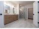 Bright bathroom featuring a double sink vanity, frameless glass shower, and neutral tile flooring at 512 Winston Croft Cir # 56, Johns Creek, GA 30022