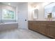 Primary bathroom featuring double vanity, large tub, and neutral-toned tile flooring at 512 Winston Croft Cir # 56, Johns Creek, GA 30022