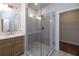Bathroom featuring a frameless glass shower with herringbone tile, a sink vanity, and a walk-in closet at 512 Winston Croft Cir # 56, Johns Creek, GA 30022