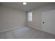 Bedroom with carpeted floor, one window, and neutral paint at 512 Winston Croft Cir # 56, Johns Creek, GA 30022