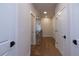 Bright hallway with hardwood floors, white doors, and a view of the staircase at 512 Winston Croft Cir # 56, Johns Creek, GA 30022
