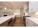 Open concept kitchen with white cabinets, stone countertops, and stainless steel appliances at 512 Winston Croft Cir # 56, Johns Creek, GA 30022
