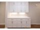 Built-in kitchen cabinetry features stone countertops, white cabinets, and modern hardware at 512 Winston Croft Cir # 56, Johns Creek, GA 30022