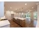 Modern kitchen with an island, stainless steel appliances, and hardwood floors leading to a room with sliding glass doors at 512 Winston Croft Cir # 56, Johns Creek, GA 30022