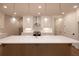 Bright kitchen features white cabinetry, stainless steel appliances, and a large center island with pendant lighting at 512 Winston Croft Cir # 56, Johns Creek, GA 30022