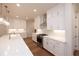 Modern kitchen with white cabinets, stainless appliances, a central island, and hardwood flooring at 512 Winston Croft Cir # 56, Johns Creek, GA 30022