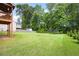 Expansive backyard with a lush lawn and mature trees, perfect for outdoor activities at 1016 Buckeye Ln, Villa Rica, GA 30180