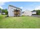 Large backyard featuring a wooden deck, spacious lawn, and landscaping at 1016 Buckeye Ln, Villa Rica, GA 30180