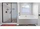 Modern bathroom showcasing a glass-enclosed shower and a separate soaking tub at 1016 Buckeye Ln, Villa Rica, GA 30180