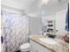 Bright bathroom with granite countertop vanity, shower-tub combination, and linen storage at 1016 Buckeye Ln, Villa Rica, GA 30180