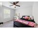 Cozy bedroom features a ceiling fan, neutral carpet, and a window with blinds at 1016 Buckeye Ln, Villa Rica, GA 30180
