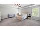 Spacious bedroom with a ceiling fan, neutral walls, carpet, and lots of natural light at 1016 Buckeye Ln, Villa Rica, GA 30180