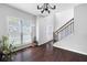 Open foyer with hardwood floors, staircase, and large window, filling the space with sunlight at 1016 Buckeye Ln, Villa Rica, GA 30180