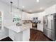 Modern kitchen featuring white cabinets, granite countertops, and stainless steel appliances at 1016 Buckeye Ln, Villa Rica, GA 30180