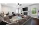 Spacious living room featuring dark wood floors, a fireplace, and plenty of natural light at 1016 Buckeye Ln, Villa Rica, GA 30180