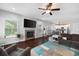 Sunlit living room with a fireplace, hardwood floors, and an open flow to the kitchen area at 1016 Buckeye Ln, Villa Rica, GA 30180