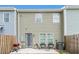 View of back of home and patio area with a grill and chairs at 11730 Chatham Dr, Hampton, GA 30228