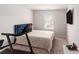 This is a standard carpeted bedroom with one window and a mounted television at 11730 Chatham Dr, Hampton, GA 30228