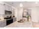Well-lit kitchen featuring grey cabinets, stainless steel appliances, and granite countertops at 11730 Chatham Dr, Hampton, GA 30228