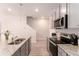 Stylish kitchen with granite countertops, stainless steel appliances, and bright lighting at 11730 Chatham Dr, Hampton, GA 30228