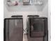This laundry room has a washer and dryer with wire shelving for storage at 11730 Chatham Dr, Hampton, GA 30228