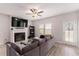 Inviting living room with fireplace, TV, ceiling fan, and access to the outside at 11730 Chatham Dr, Hampton, GA 30228