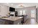 Open-concept living room featuring a fireplace, TV, ceiling fan, and access to the outside at 11730 Chatham Dr, Hampton, GA 30228