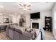 Spacious living room featuring a fireplace, TV, ceiling fan, and easy access to kitchen at 11730 Chatham Dr, Hampton, GA 30228