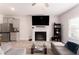Cozy living room features a fireplace, TV, and a view of the kitchen area at 11730 Chatham Dr, Hampton, GA 30228