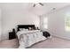 Spacious bedroom with a ceiling fan, neutral carpet, and plenty of natural light at 11730 Chatham Dr, Hampton, GA 30228