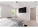 Brightly lit bedroom featuring a TV and access to an ensuite bathroom at 11730 Chatham Dr, Hampton, GA 30228