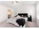 Bedroom featuring a ceiling fan, carpet floors, and access to the ensuite bathroom at 11730 Chatham Dr, Hampton, GA 30228